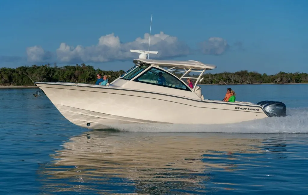 Family cruising in a Grady White 37 foot Freedom 375 on a waterway in the late afternoon.