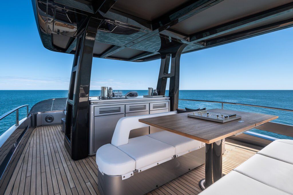 Aft deck dining area with retractable stern platform visible