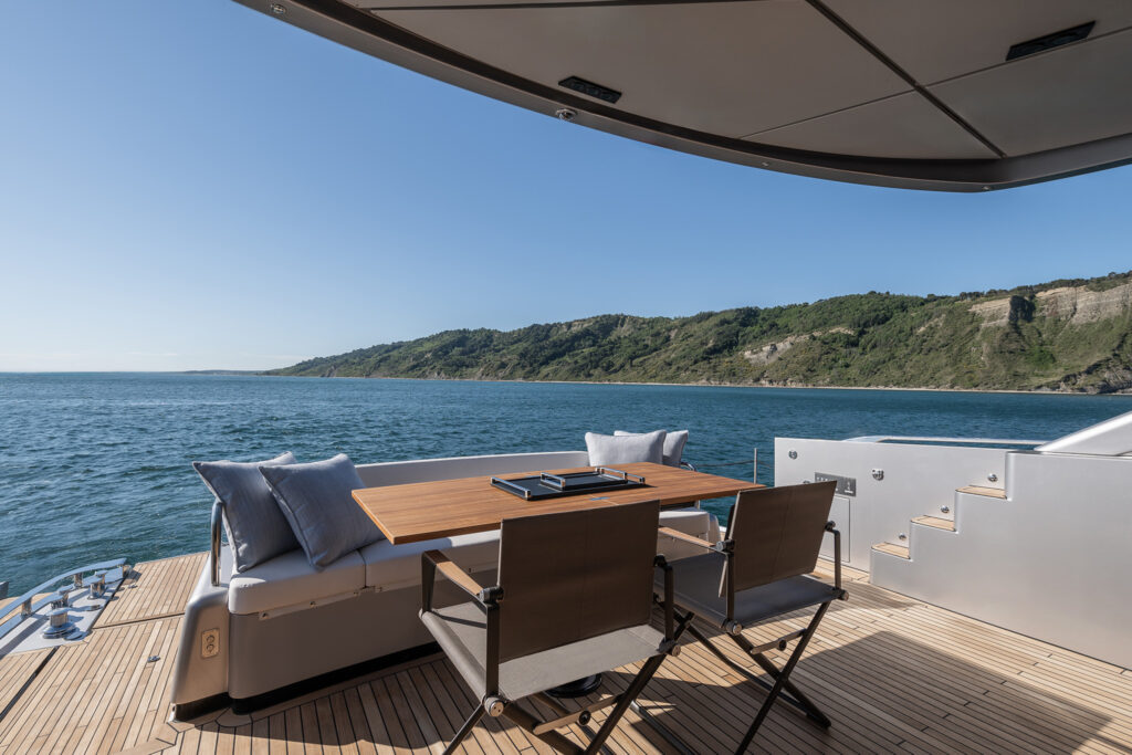 Aft deck dining area with retractable stern platform visible
