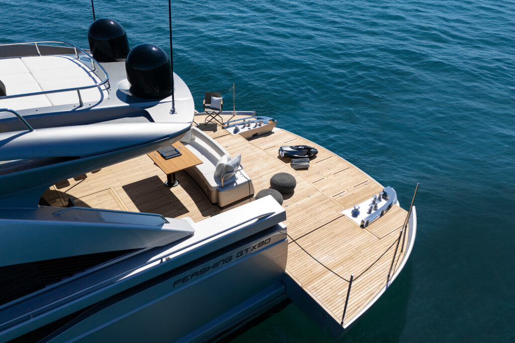 Aft deck dining area with retractable stern platform visible