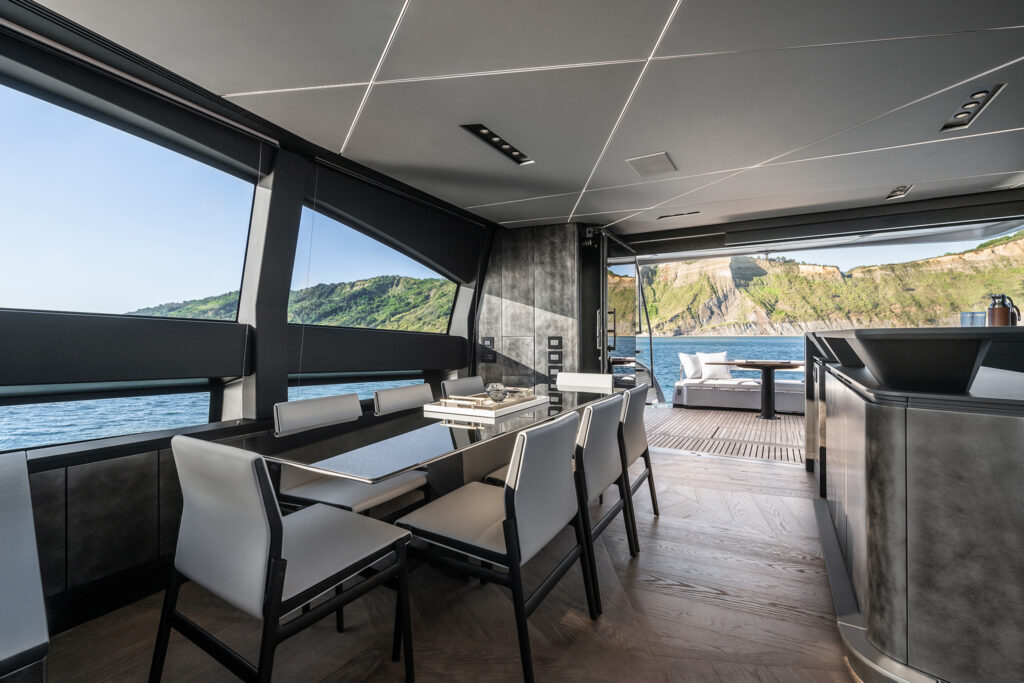Dining area with panoramic windows highlighting the indoor-outdoor design philosophy
